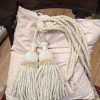 Light cream rope & tassel tiebacks with velvet detailing