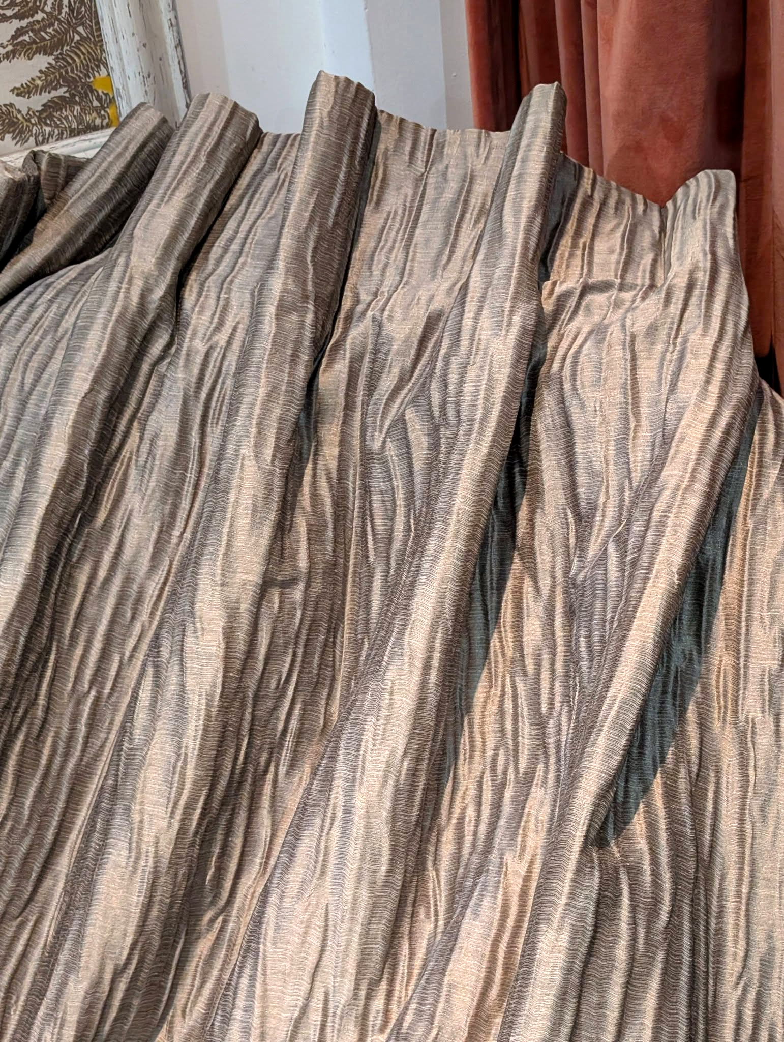 goblet5 - Divinely Vintage Interiors Close-up of gathered striped fabric in gray and beige tones, hanging in folds.