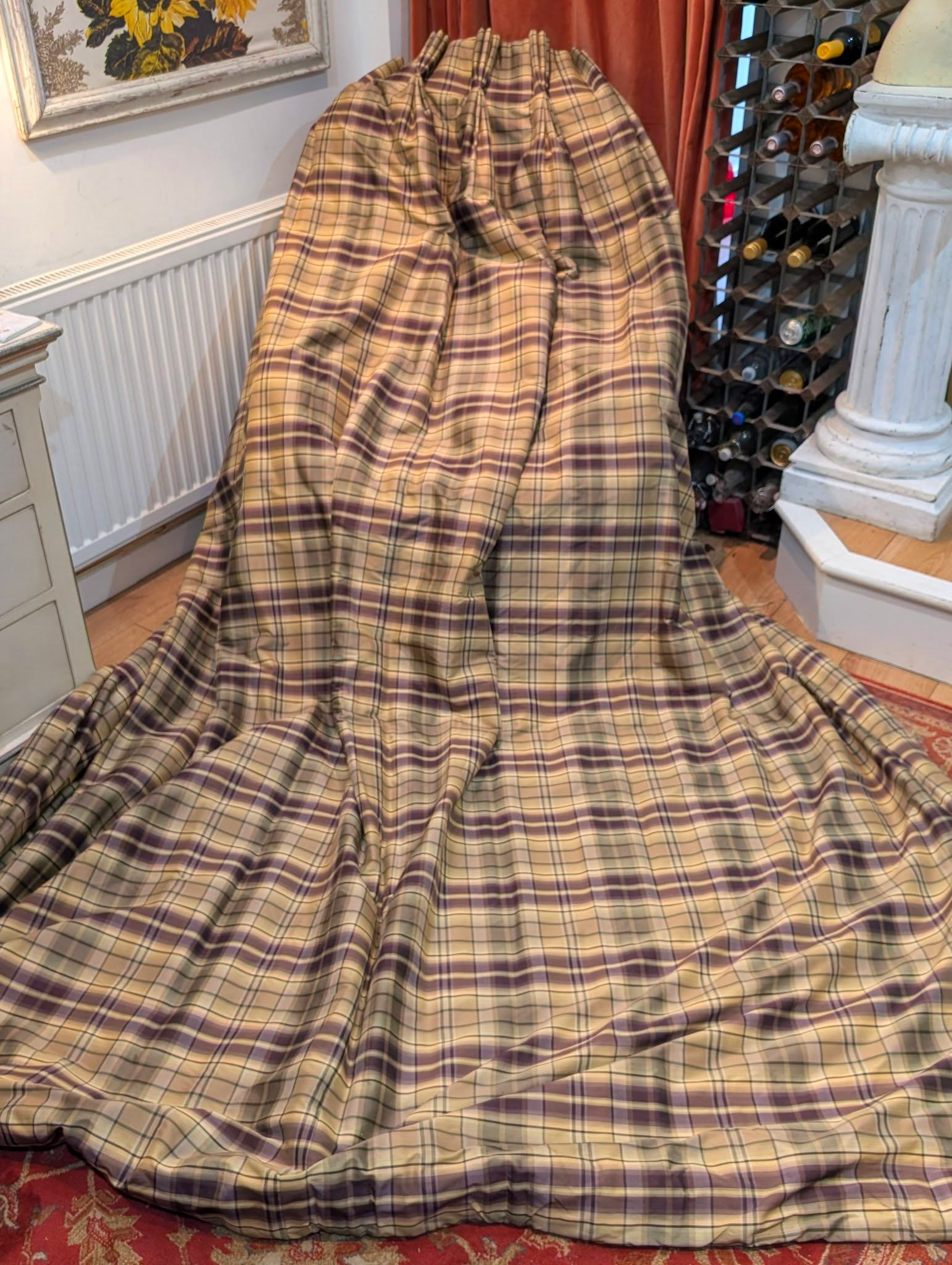 rach1 - Divinely Vintage Interiors Large plaid-covered chair or sofa draped in beige and burgundy cloth in a cozy room.