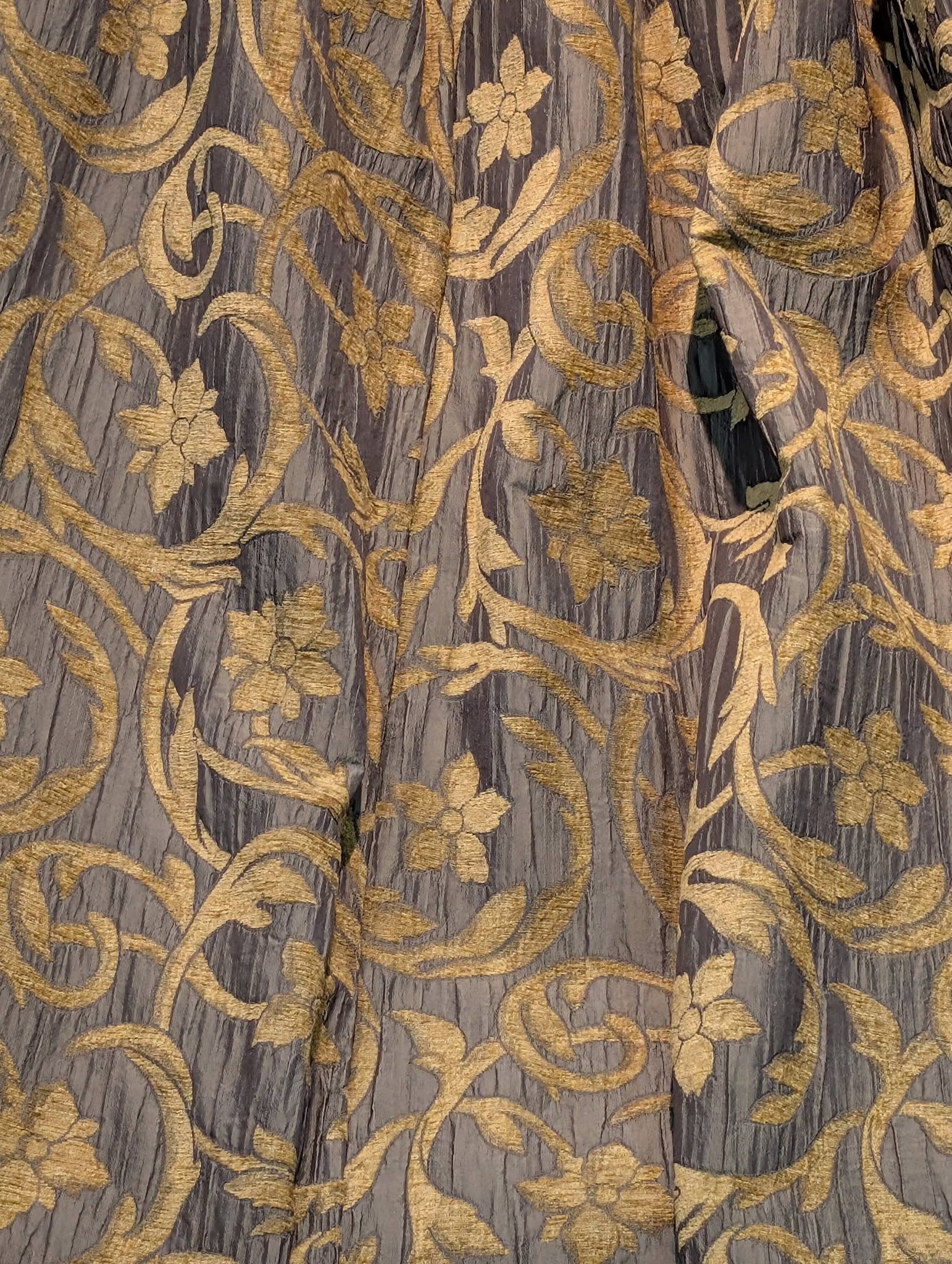 rachel4 - Divinely Vintage Interiors Gold embroidered floral vine pattern on dark grey fabric; ornate textile with raised gold threadwork and leafy motifs.