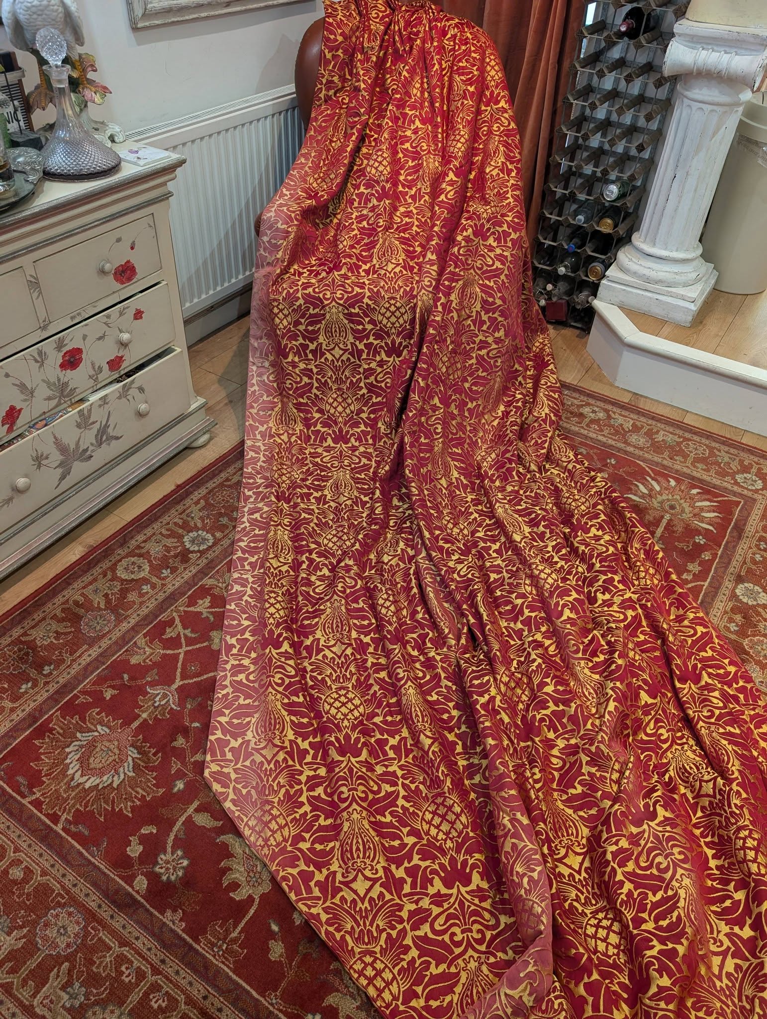 rich14 - Divinely Vintage Interiors Red and gold damask fabric draped over a chair in a vintage room setting.