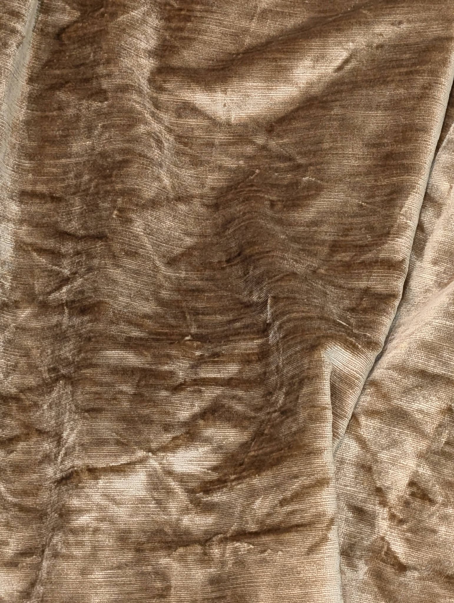 judith7 - Divinely Vintage Interiors Close-up of brown velvety fabric with soft folds and subtle horizontal stripes.