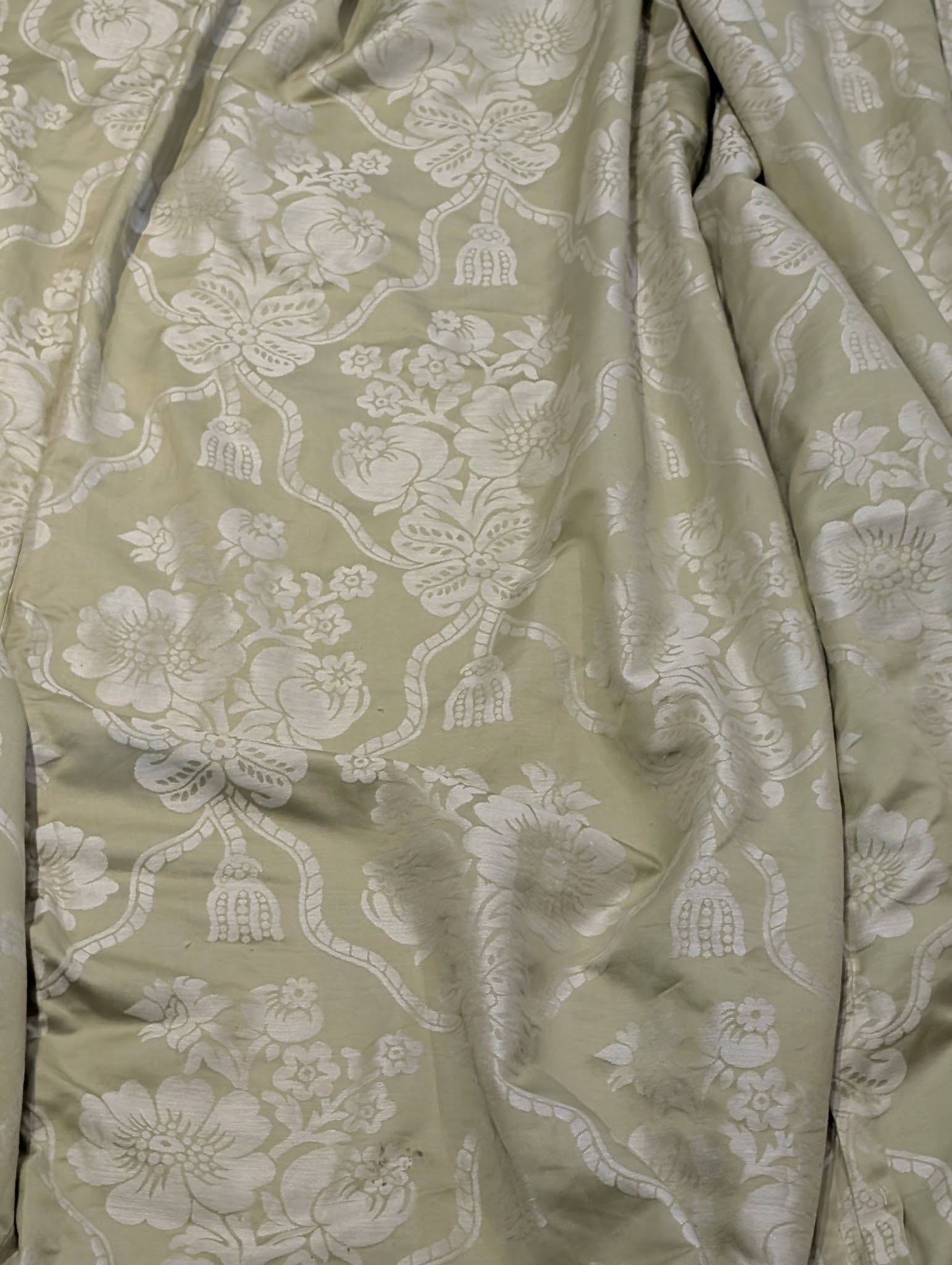 bed2 - Divinely Vintage Interiors Close-up of pale green fabric with a white floral damask pattern
