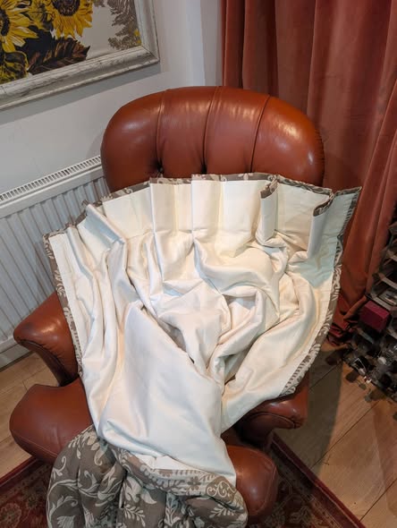 cream12 - Divinely Vintage Interiors Brown leather armchair with a large white curtain draped over it in a living room setting with a radiator nearby.