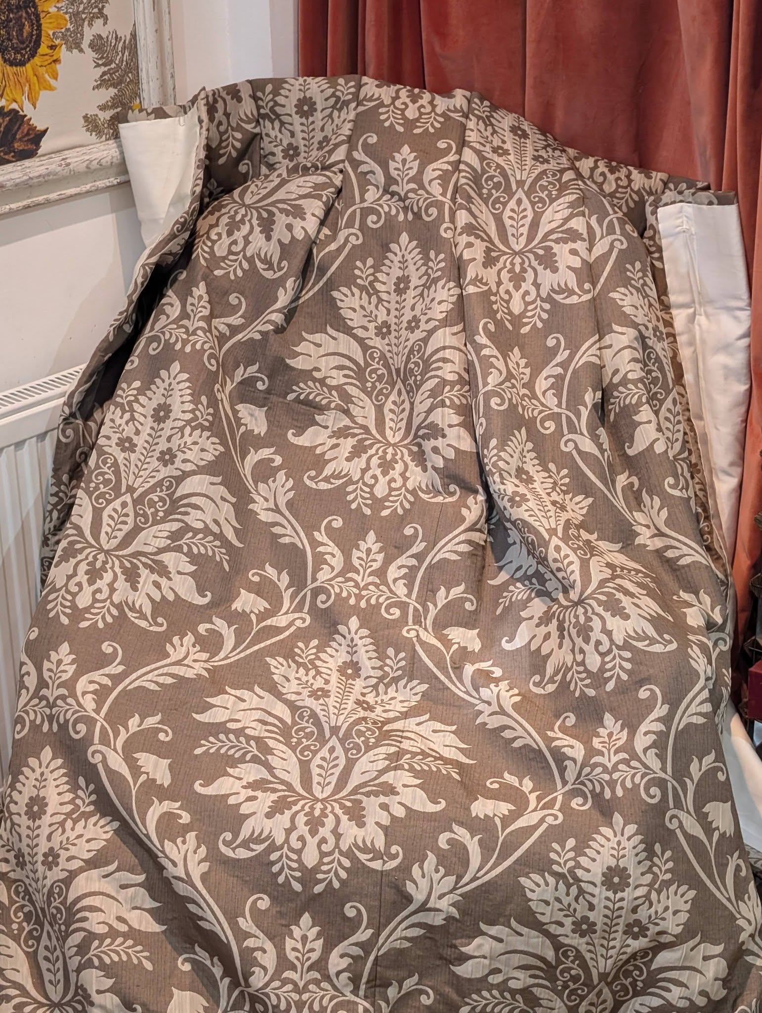 cream3 - Divinely Vintage Interiors Close-up of a chair upholstered in brown damask fabric with beige floral patterns.
