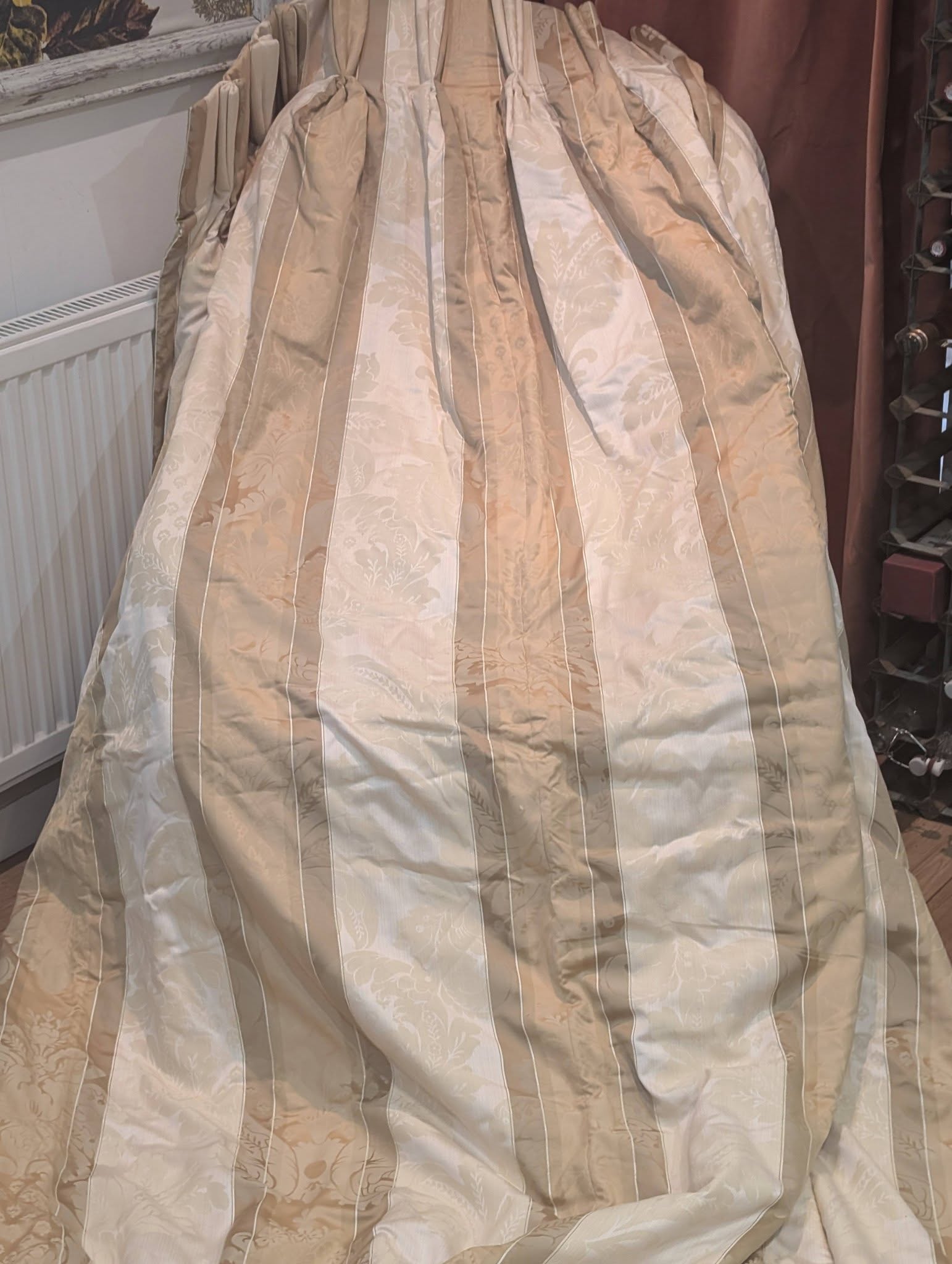 dam4 - Divinely Vintage Interiors Beige damask-patterned bedspread with vertical stripes draped over a bed, filling the frame.