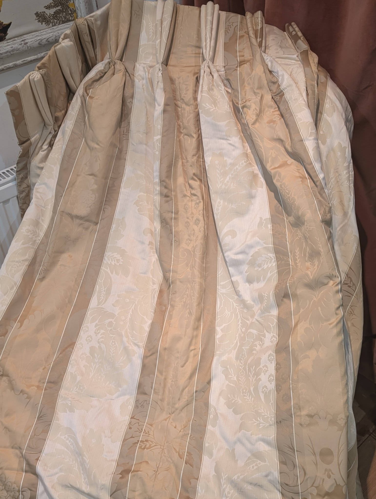 dam6 - Divinely Vintage Interiors Beige floral-patterned quilt with vertical stripes, draped in soft folds.