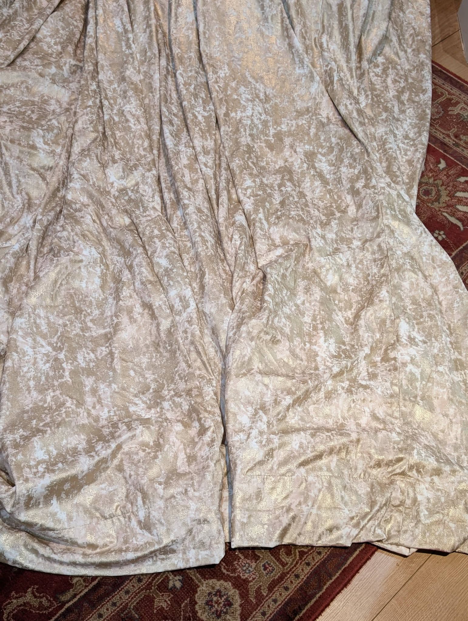 film2 - Divinely Vintage Interiors Beige crushed-velvet fabric with white marbled pattern spread over a rug and wooden floor.