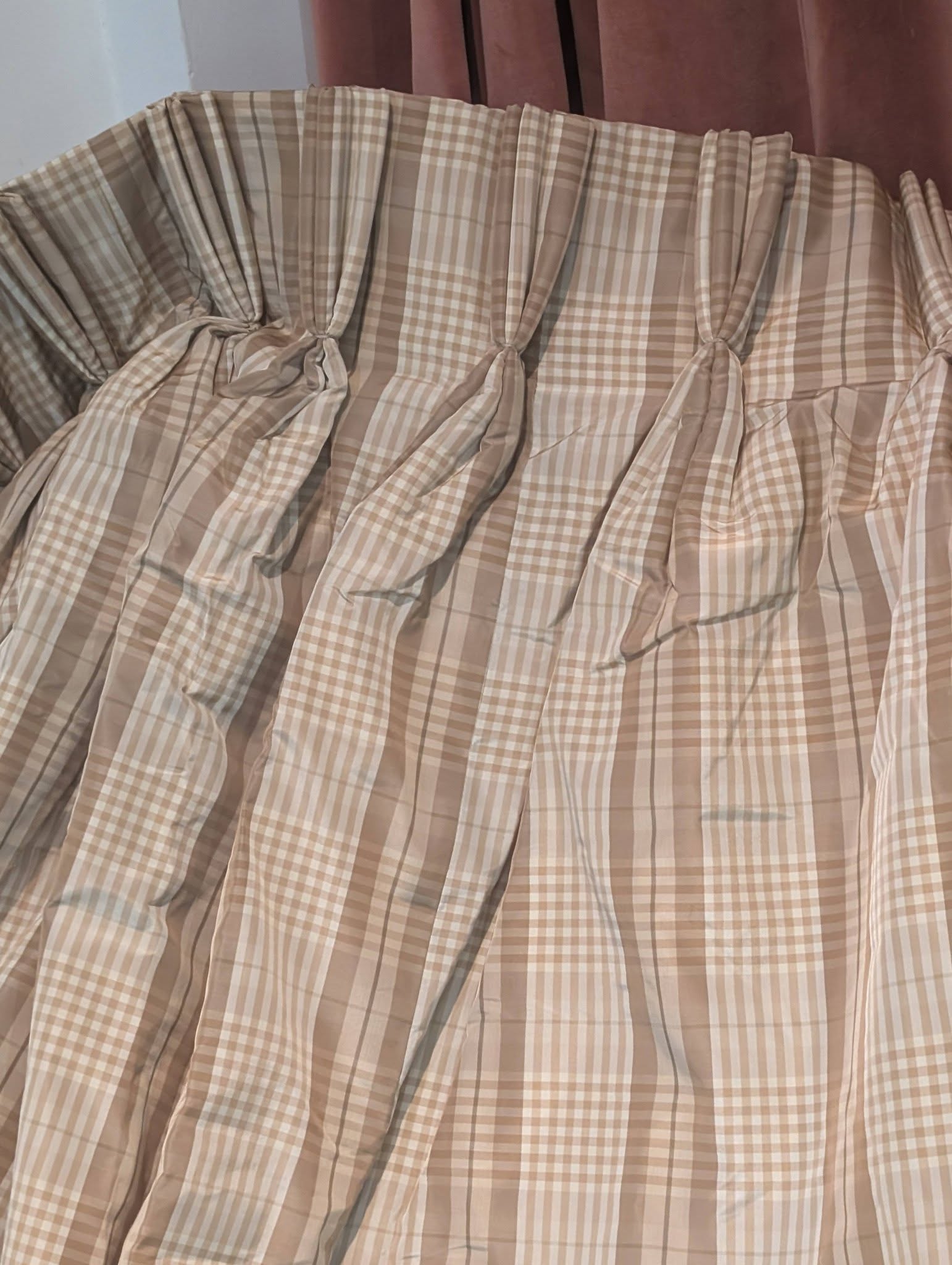 ging5 - Divinely Vintage Interiors Beige and white plaid curtains with gathered pleats hanging along a wall.