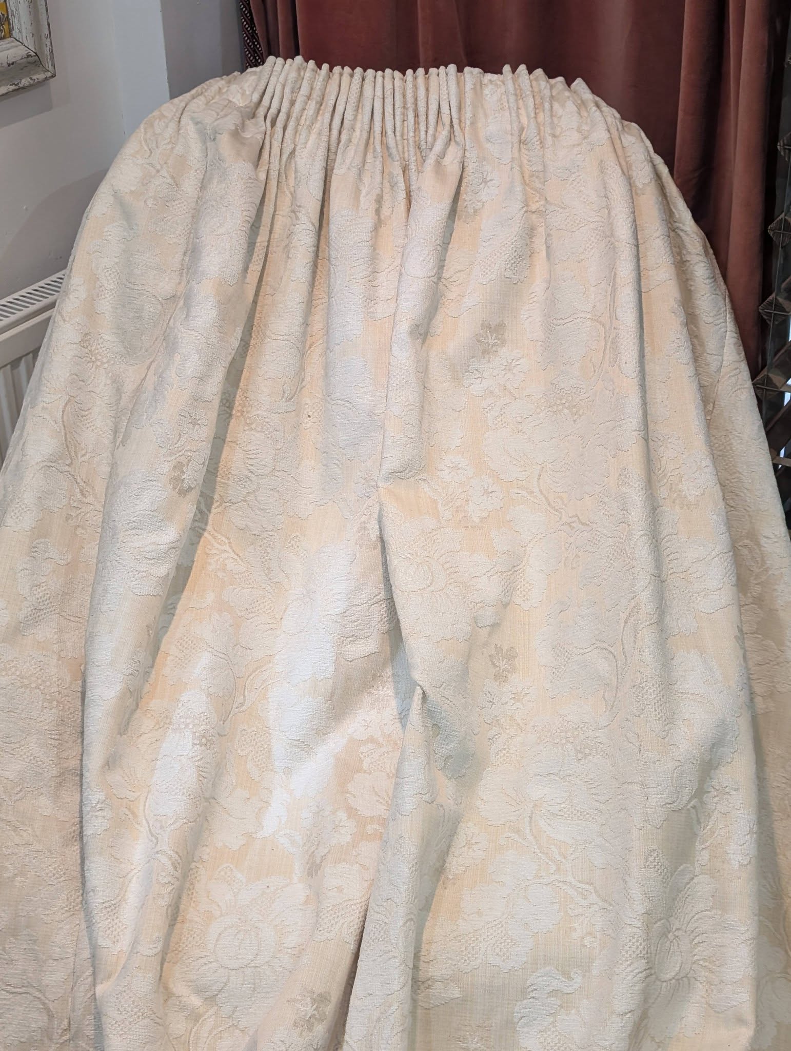 leila4 - Divinely Vintage Interiors Cream damask curtain fabric with a shirred, pleated header, hanging in soft folds.