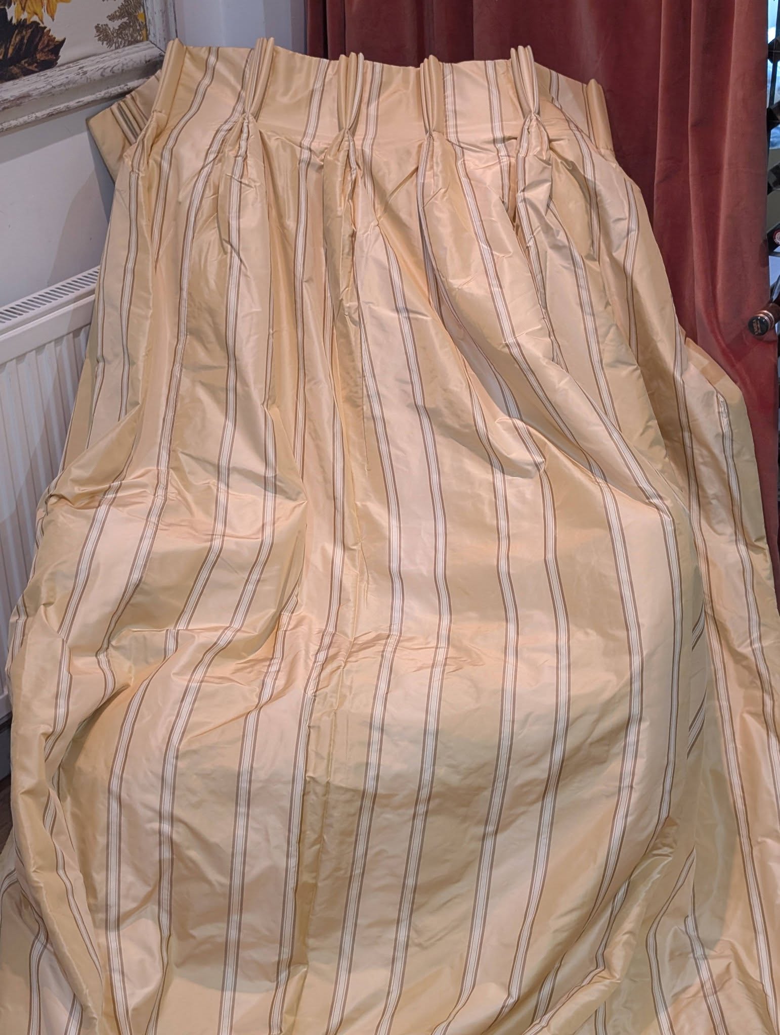 silk3 - Divinely Vintage Interiors Beige striped curtain or bedspread draped over furniture, with vertical brown stripes and gathered sections at the top.