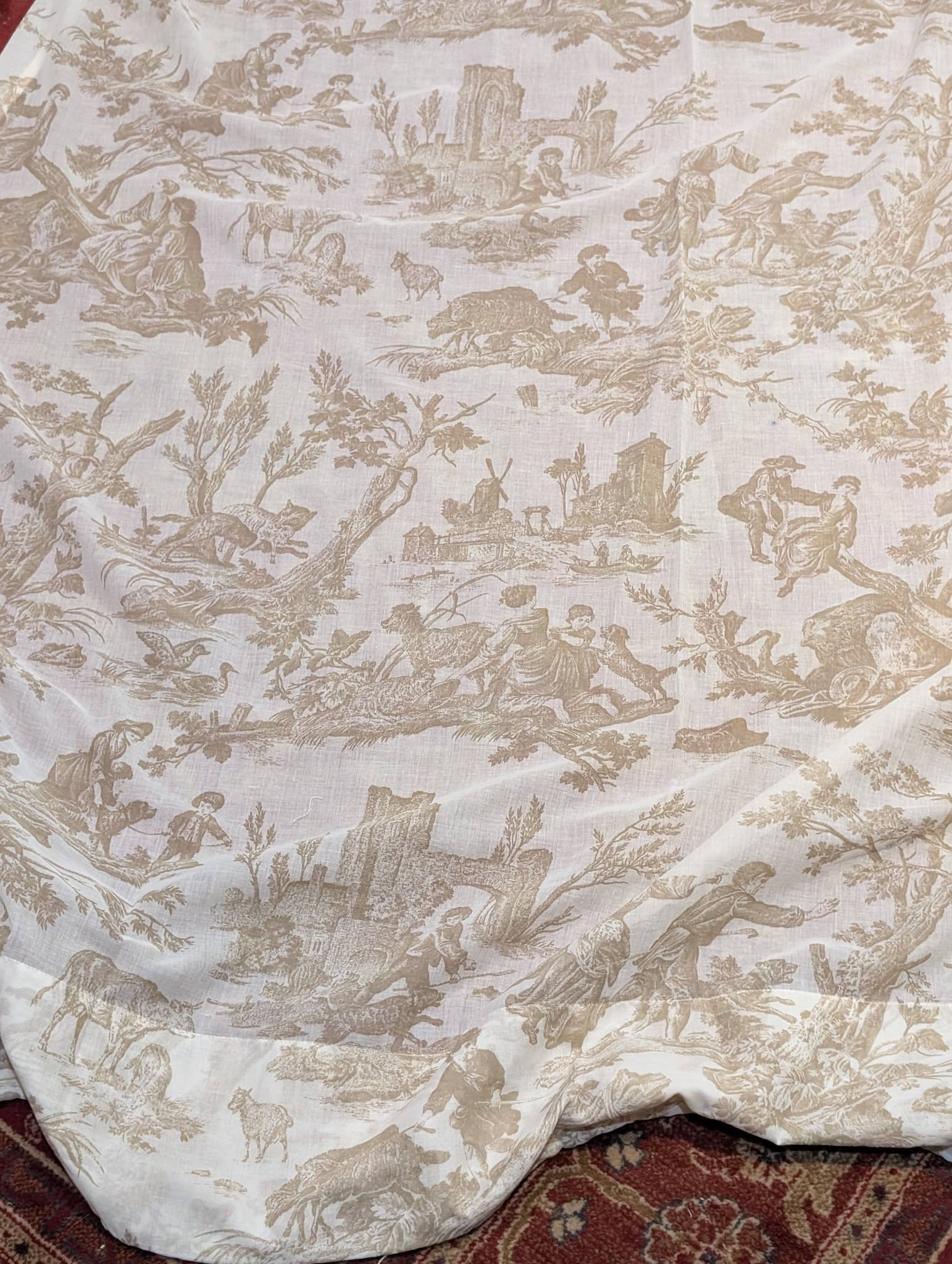 Beige toile fabric pattern showing pastoral scenes, people, animals, trees, and ruins.