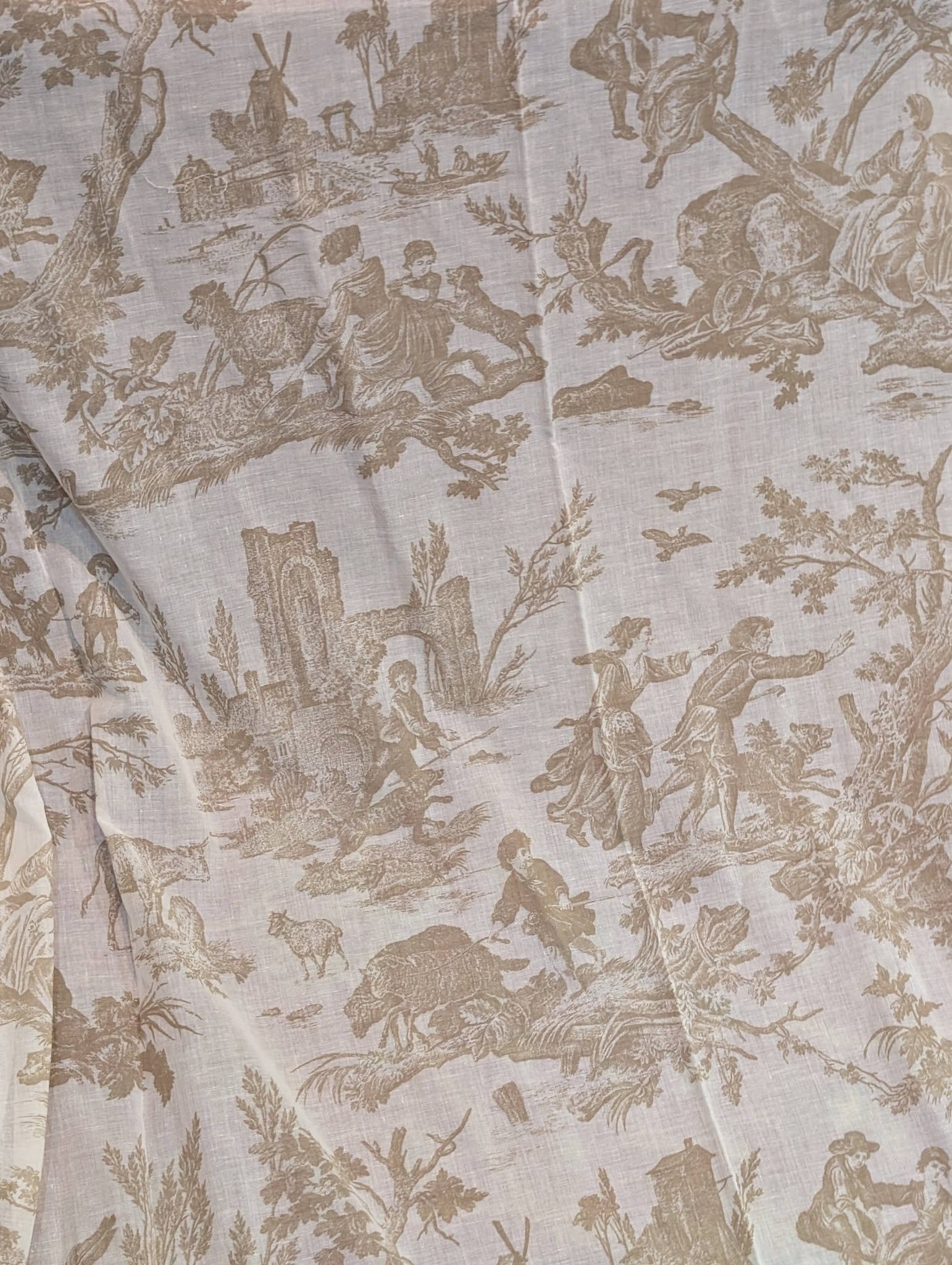 Beige toile fabric pattern with pastoral scenes: villagers, animals, trees, and arches.